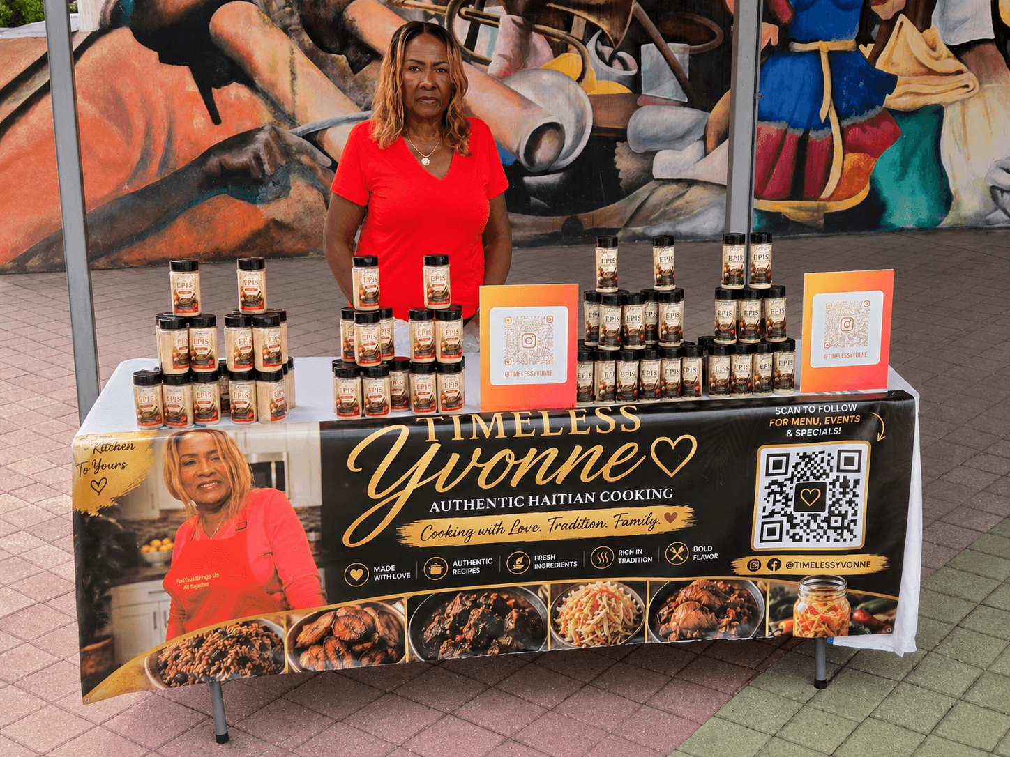 Yvonne standing behind a Timeless Yvonne table display at a food festival